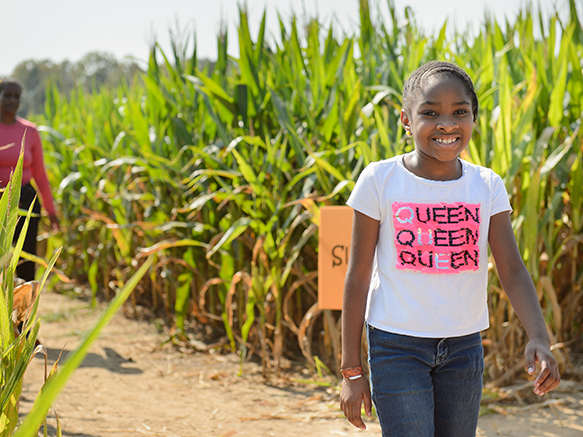 girl in front of corn maze entrance