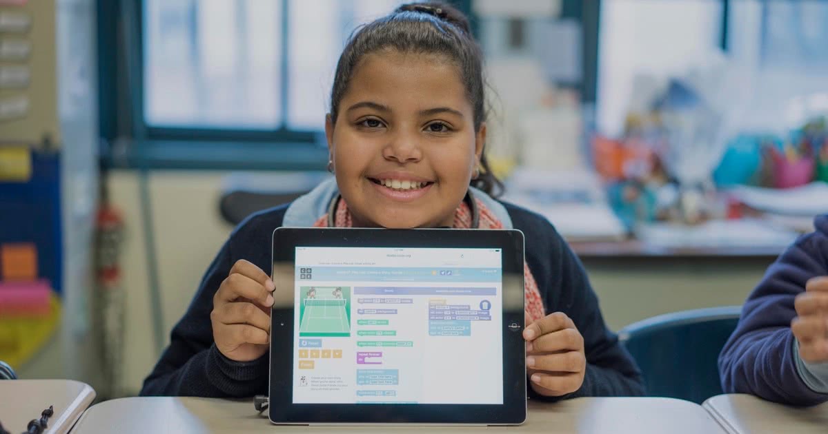 girl posing behind iPad with code