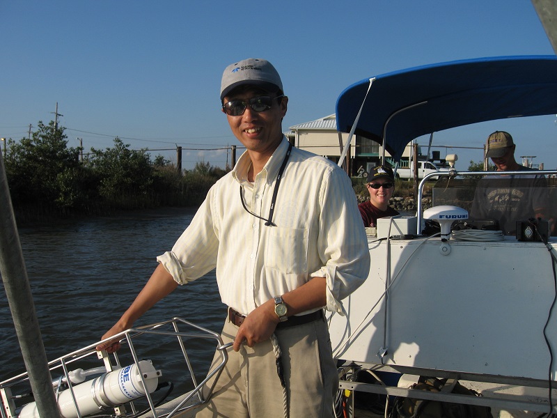 a man in sunglassess and a baseball cap on a boat