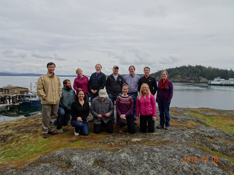 a group of people pose near a dock in the Arctic