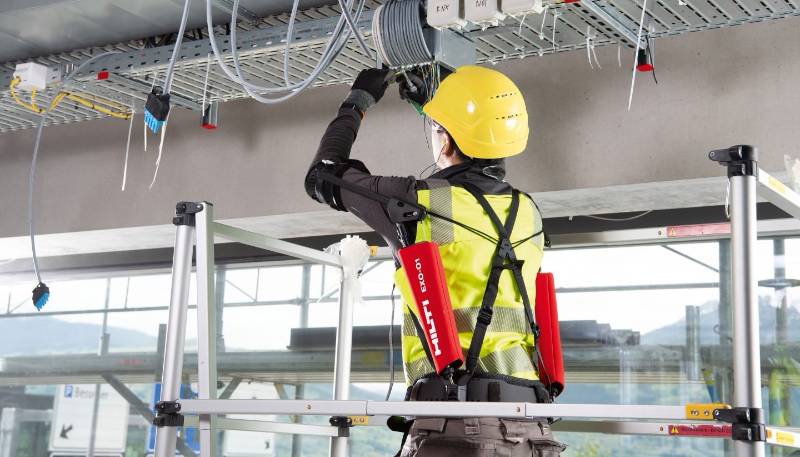 Construction worker standing on elevaed lift