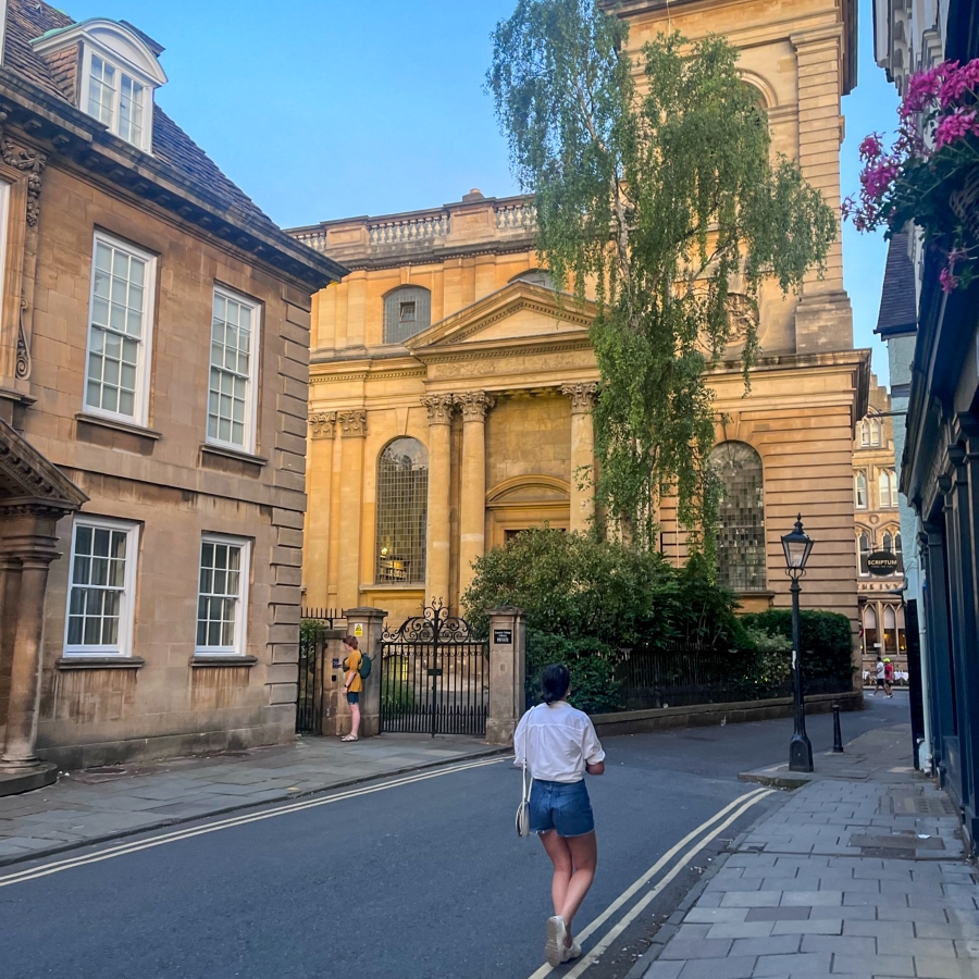 student walks through a scenic European town