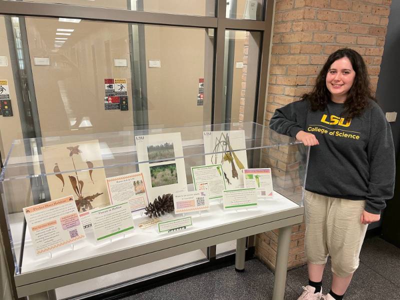 Olivia standing in front of display case