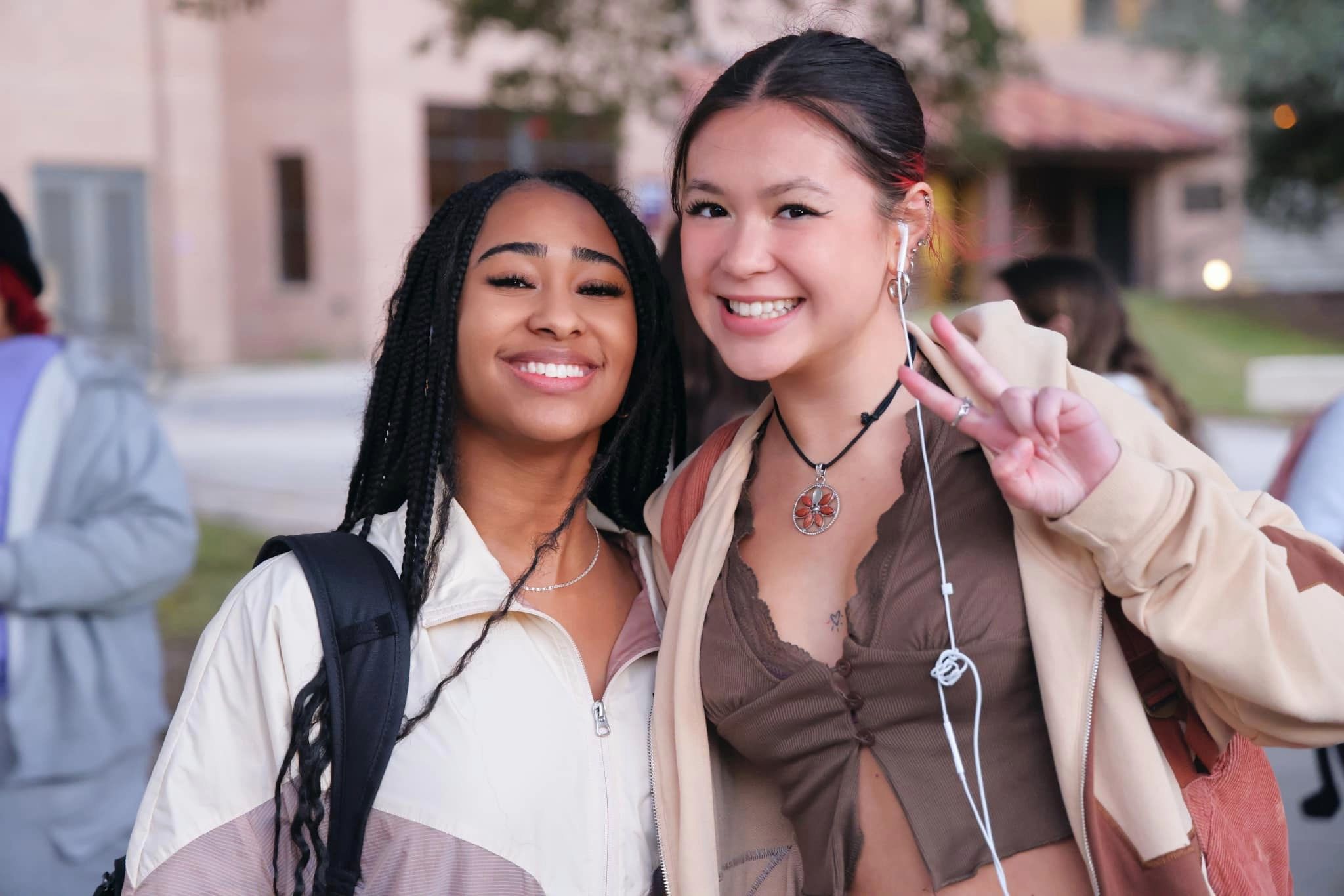 Students smiling and one is holding up a peace sign