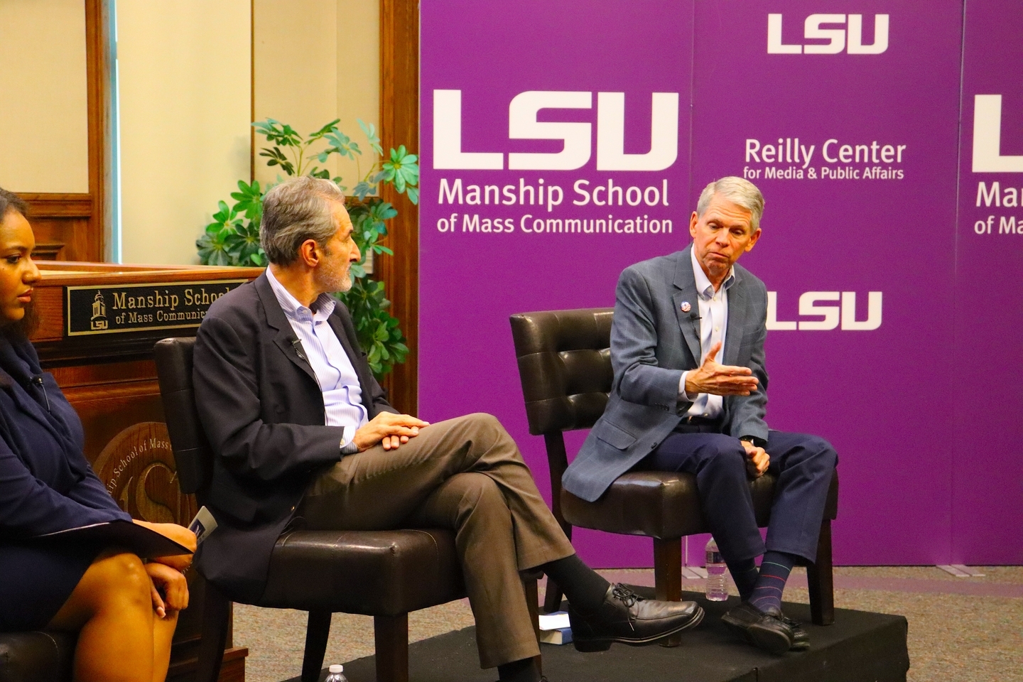 An image of the front of the Holliday Forum with the event moderator to the left, guest speaker, Samuel Freedman, in the middle and other guest speaker, Bob Mann to the right.