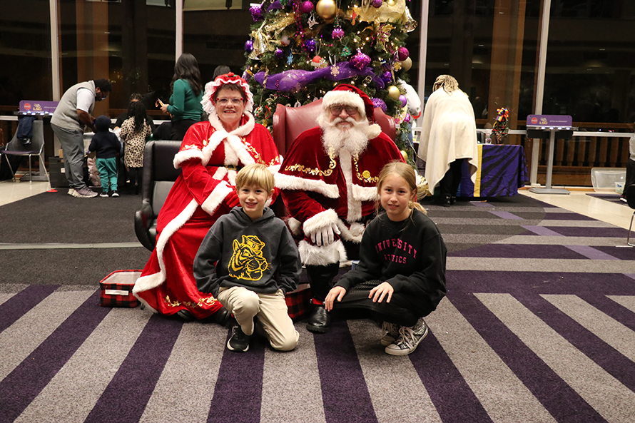 children with Santa and Mrs. Claus